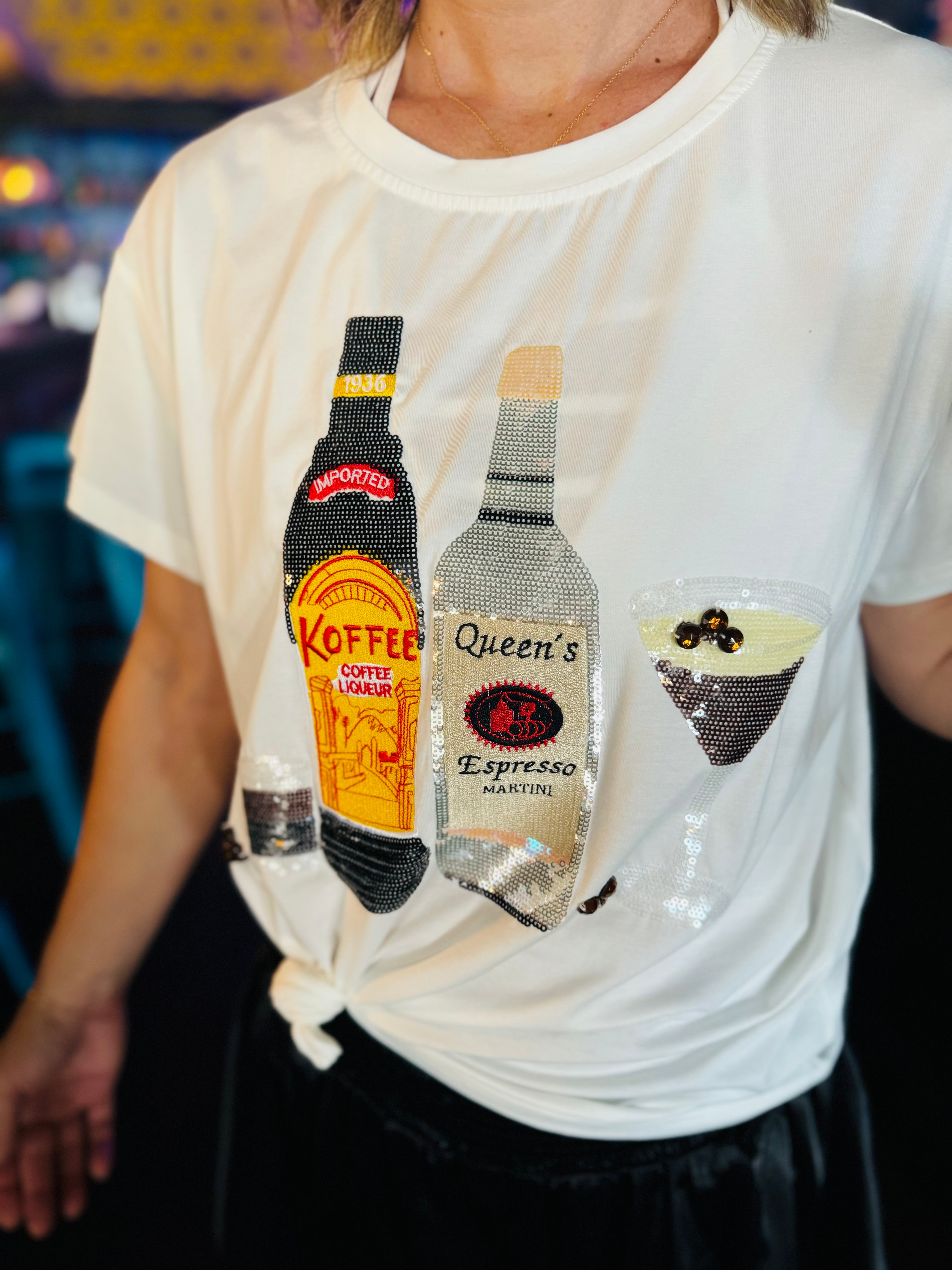 Close up of the Queen Of Sparkle Espresso Tee with sequins and rhinestones.