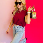 Side profile of the top worn by a model striking a playful pose, showing off the bubble hem.
