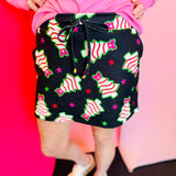 Black skort with pink-bowed Christmas tree print, pockets, and built-in shorts.