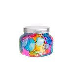 Rainbow watercolor glass jar candle with vibrant colors and a tropical fruit and citrus Volcano scent; decorative 19oz candle for home fragrance and style.