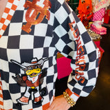 Close up Queen of Sparkles UT orange and black checkered cardigan with sequin and beading and rhinestone buttons.