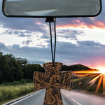 Cross-shaped hair-on-hide and leather car freshener charm, stitched design.
