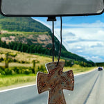 Cross-shaped hair-on-hide and leather car freshener charm, stitched design.