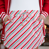 Red, pink, and green striped skort with drawstring waist, pockets, and built-in shorts.