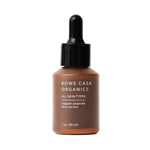 A bottle of Rowe Casa Organics Copper Peptide Face Serum with a dropper, labeled for all skin types.