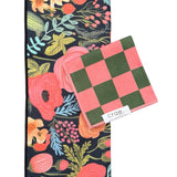 Crae Colleen/Melon towel set with floral black hand towel and pink-green checkered washcloth.