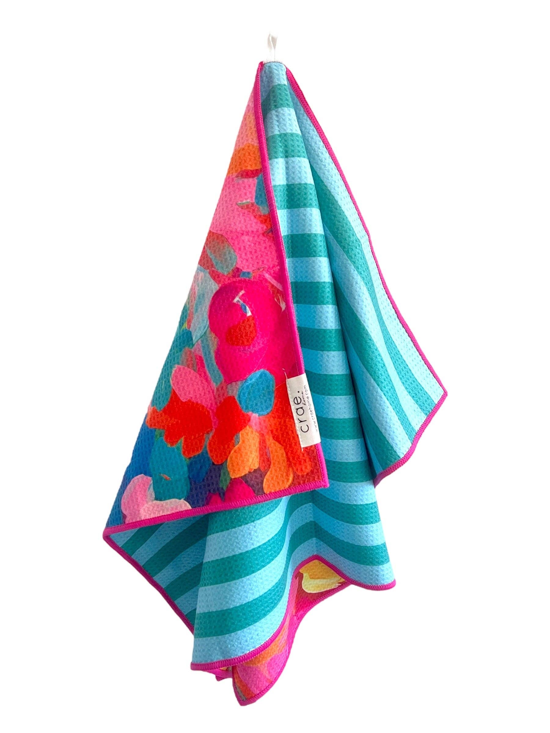 Reversible microfiber hand towel with turquoise stripes, floral pattern, and bright pink trim, 19x29 inches.