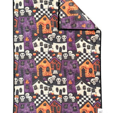 Crae Frightville microfiber hand towel, 17x27 in, Halloween print with haunted houses, pumpkins, skulls, and checkerboard.