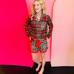 Plaid and leopard pajama set with ruffle trim and tie waist for festive lounging.