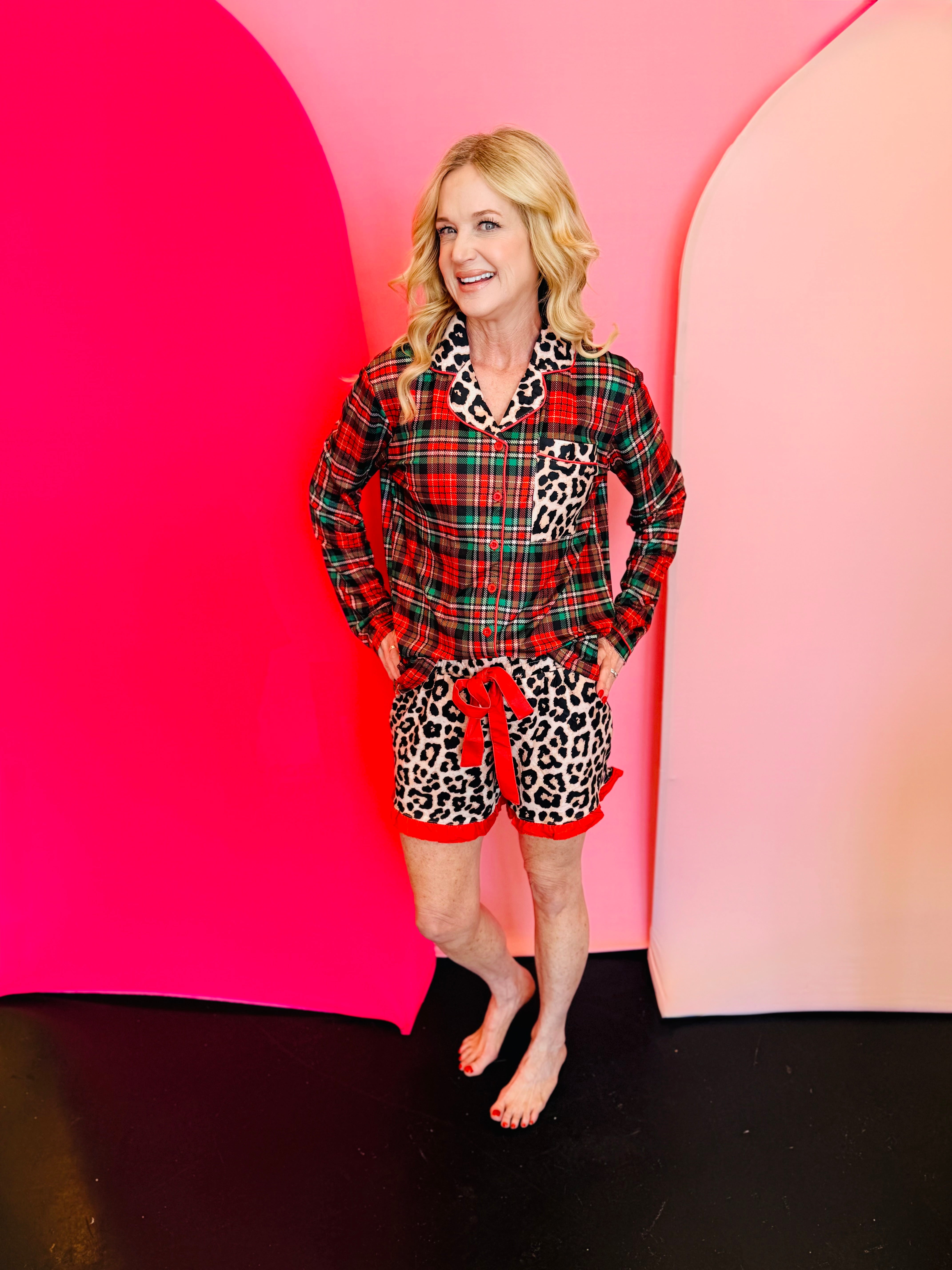 Plaid and leopard pajama set with ruffle trim and tie waist for festive lounging.