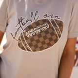 Cream tultex soft tee with brown checkered football graphics.