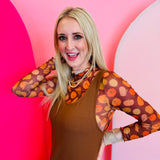 A sheer brown mesh top with a mock neck and colorful pumpkin print.