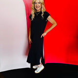 Black short sleeve midi dress with a round neckline and subtle side slit, made from a soft, stretchy cotton blend.