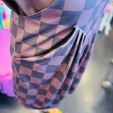 side pleats of chocolate checkered overall shorts