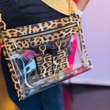 Leopard-trimmed clear crossbody bag with gold hardware and built-in sunglasses holder—stylish, functional, and stadium-ready.