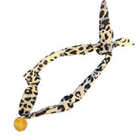 Black and white leopard print satin scarf with gold starburst medallion charm necklace.