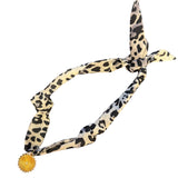 Black and white leopard print satin scarf with gold starburst medallion charm necklace.