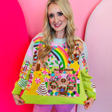 Lime green Christmas sweater with sequin gingerbread village, candy canes, nutcrackers, and rainbows.
