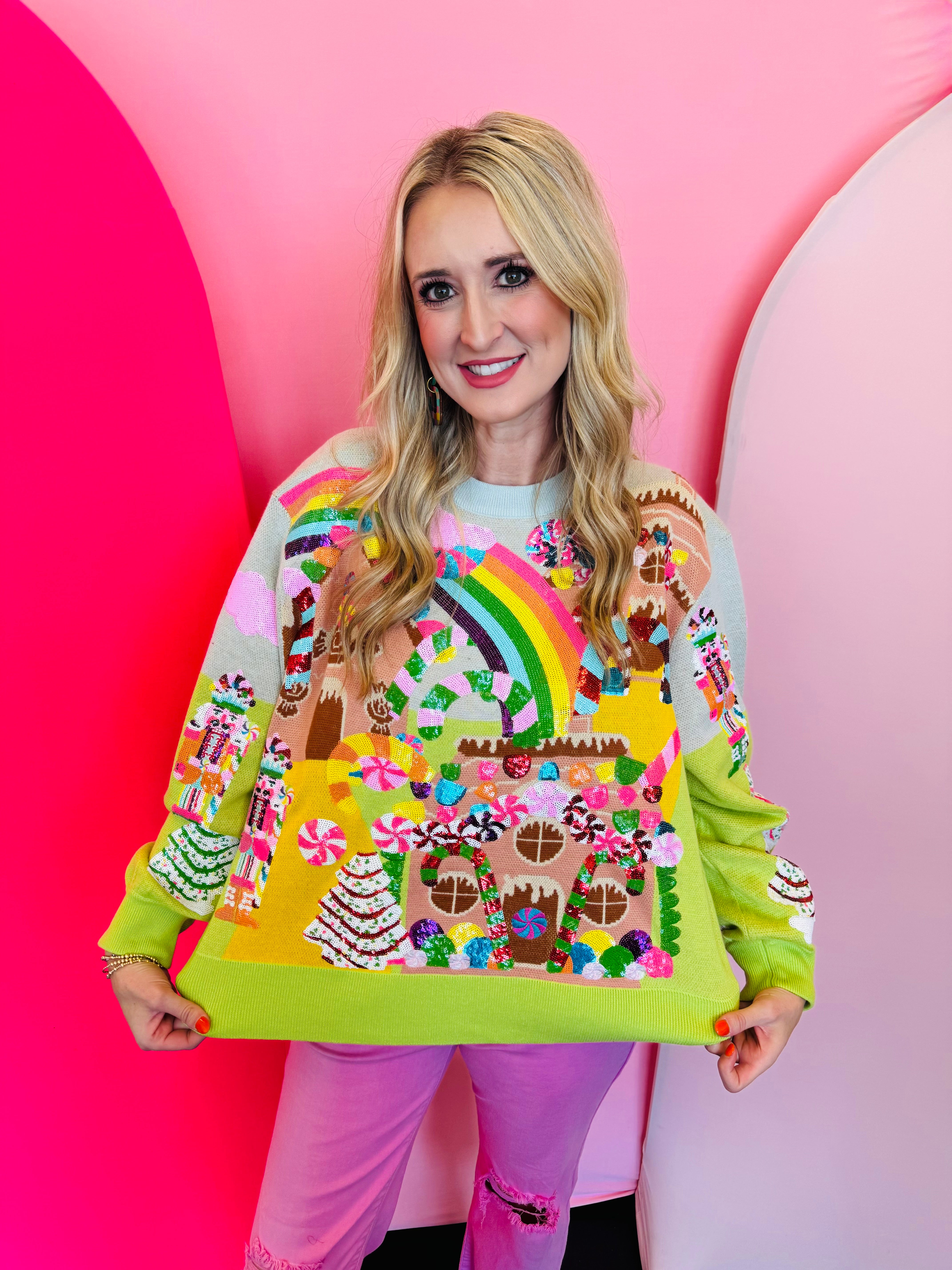 Lime green Christmas sweater with sequin gingerbread village, candy canes, nutcrackers, and rainbows.