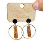 Gold hoops with orange glitter dangles and black writing that says Bulldogs set on black stud.