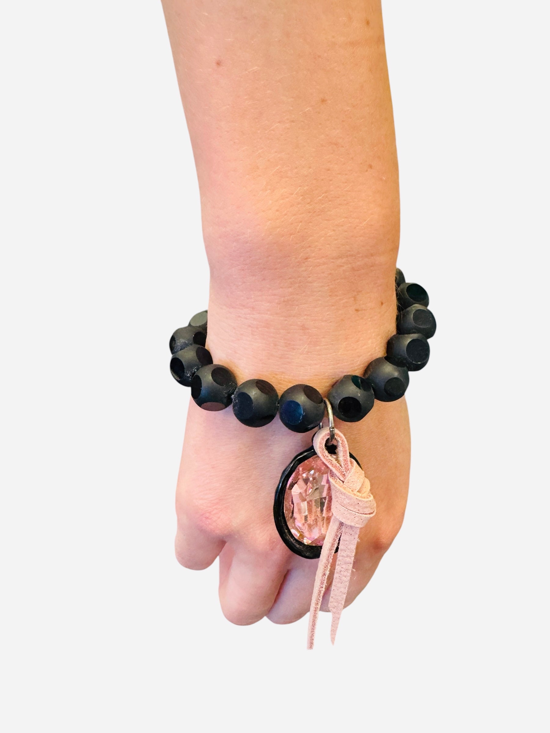 Large black and pastel pink beaded bracelet with oversized pastel pink rhinestone charm and leather accent