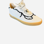 White low-top sneakers with vegan leather upper, delicate lace trim, lace-up closure, and round toe.