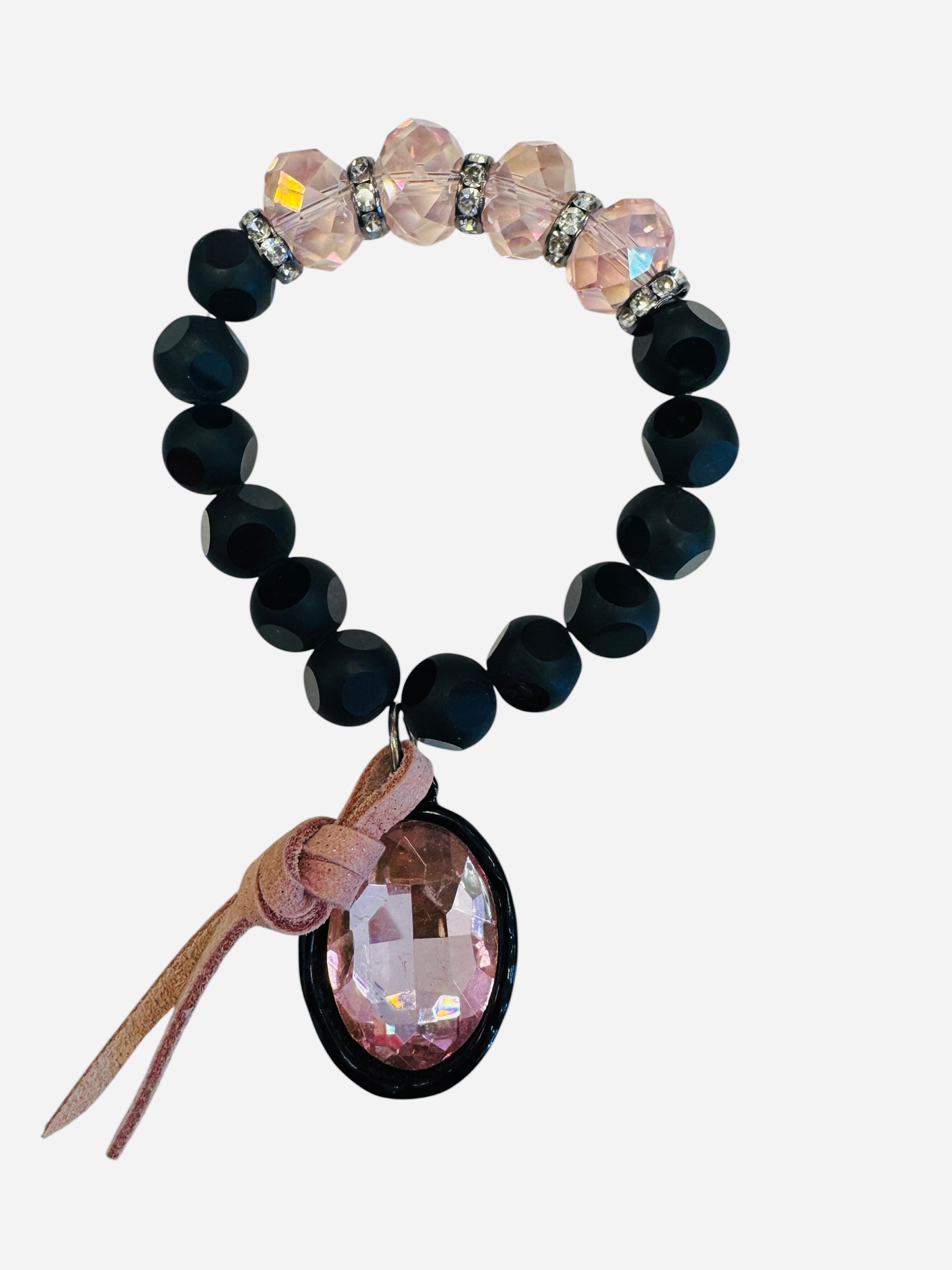 Large black and pastel pink beaded bracelet with oversized pastel pink rhinestone charm and leather accent