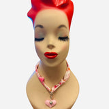 Pink and ivory floral scarf necklace with puffy pink heart charm and silver heart charm, tied in a stylish knot and designed to be worn as a necklace, bracelet, or accessory.