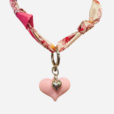 Pink and ivory floral scarf necklace with puffy pink heart charm and silver heart charm, tied in a stylish knot and designed to be worn as a necklace, bracelet, or accessory.