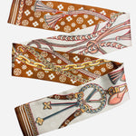 Reversible caramel and white scarf necklace with floral and rope motifs for versatile styling.