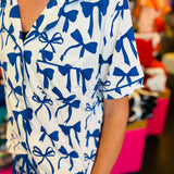 White pajama set with soft blue bow print, featuring a relaxed-fit short-sleeve top