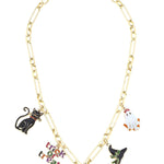A shiny gold chain necklace featuring several dangling enamel charms, including a black cat, a white ghost, a witch hat, and a "Trick or Treat" sign.
