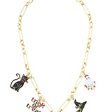 A shiny gold chain necklace featuring several dangling enamel charms, including a black cat, a white ghost, a witch hat, and a "Trick or Treat" sign.