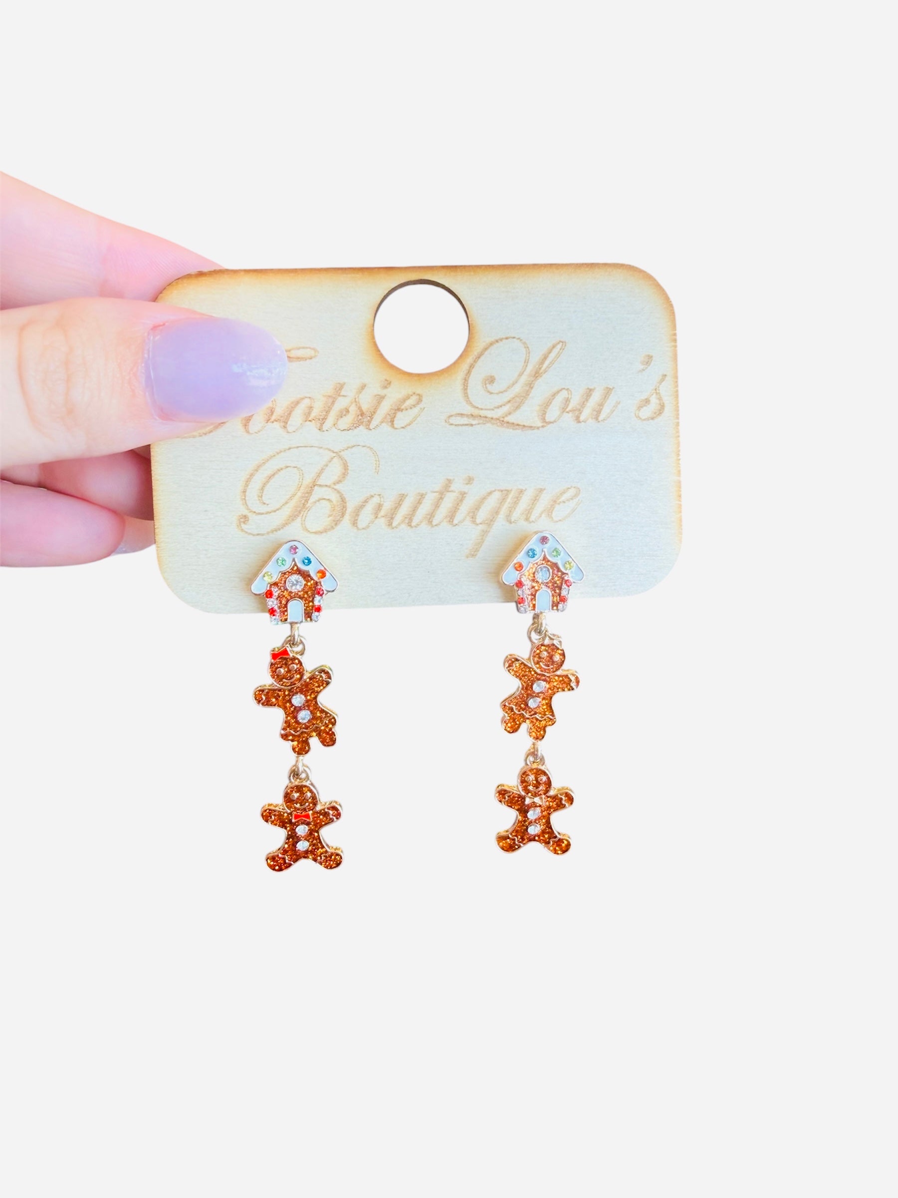Gingerbread acrylic earrings with etched icing details, festive and lightweight for holiday wear.