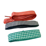Gingham shoelaces in red, black, and green check patterns, stylish replacement laces for sneakers or boots.