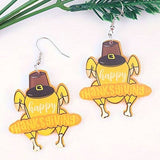 Thanksgiving turkey earrings made of acrylic in fall colors with laser-cut detail and festive charm.