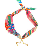 Multicolored retro-print scarf necklace featuring a hammered gold open star charm; vibrant hues of pink, teal, orange, and yellow add a playful, bold touch to any outfit.