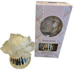 A Sweet Grace flower diffuser with a pink and white floral design, accompanied by a packaging box with a tartan pattern.