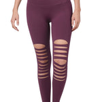 Eggplant colored stretchy leggings with destroyed front cutouts.