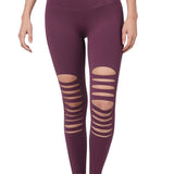 Eggplant colored stretchy leggings with destroyed front cutouts.