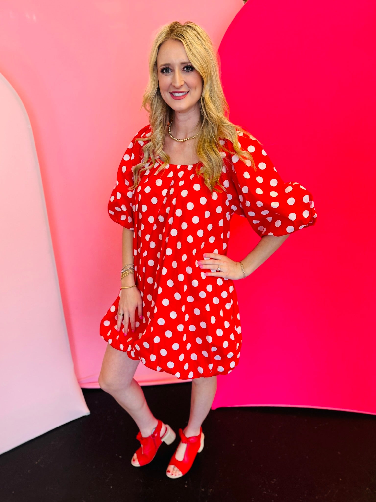 Red polka dot cotton dress with off-the-shoulder neckline, 3/4 balloon sleeves, and side pockets.