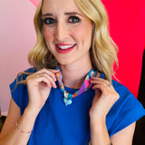 Close-up of model wearing the Blue Scarf Blue Heart Charm Necklace, featuring a soft blue printed scarf and glossy baby blue heart pendant—lightweight, adjustable, and perfect for adding a playful pop of color and charm to any outfit.