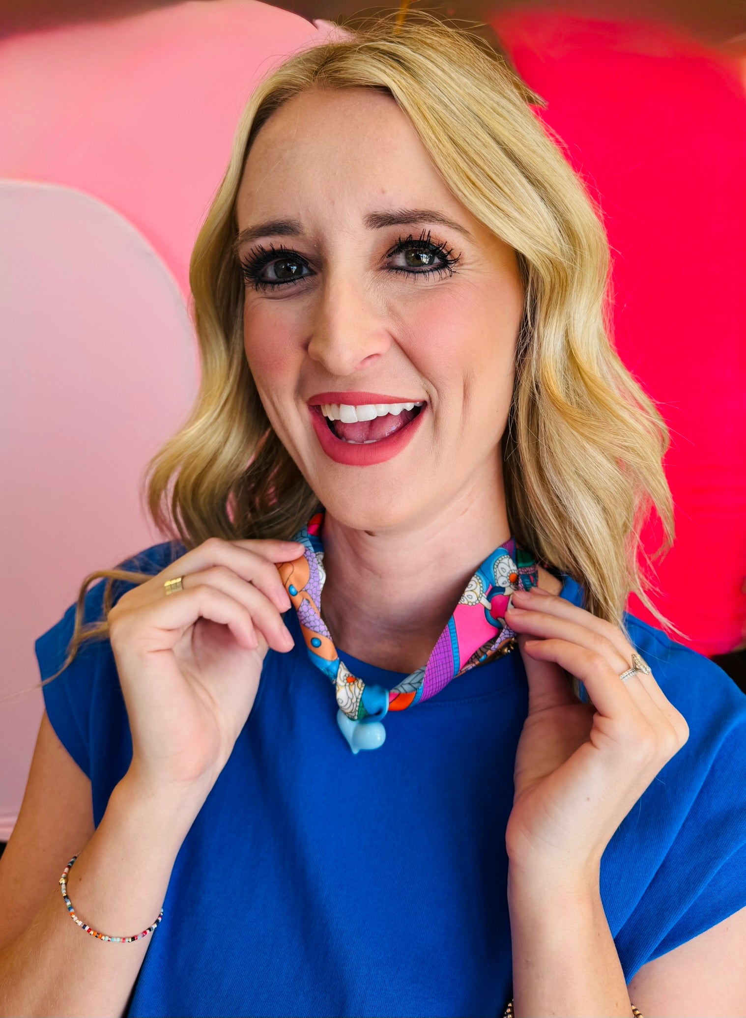 Close-up of model wearing the Blue Scarf Blue Heart Charm Necklace, featuring a soft blue printed scarf and glossy baby blue heart pendant—lightweight, adjustable, and perfect for adding a playful pop of color and charm to any outfit.