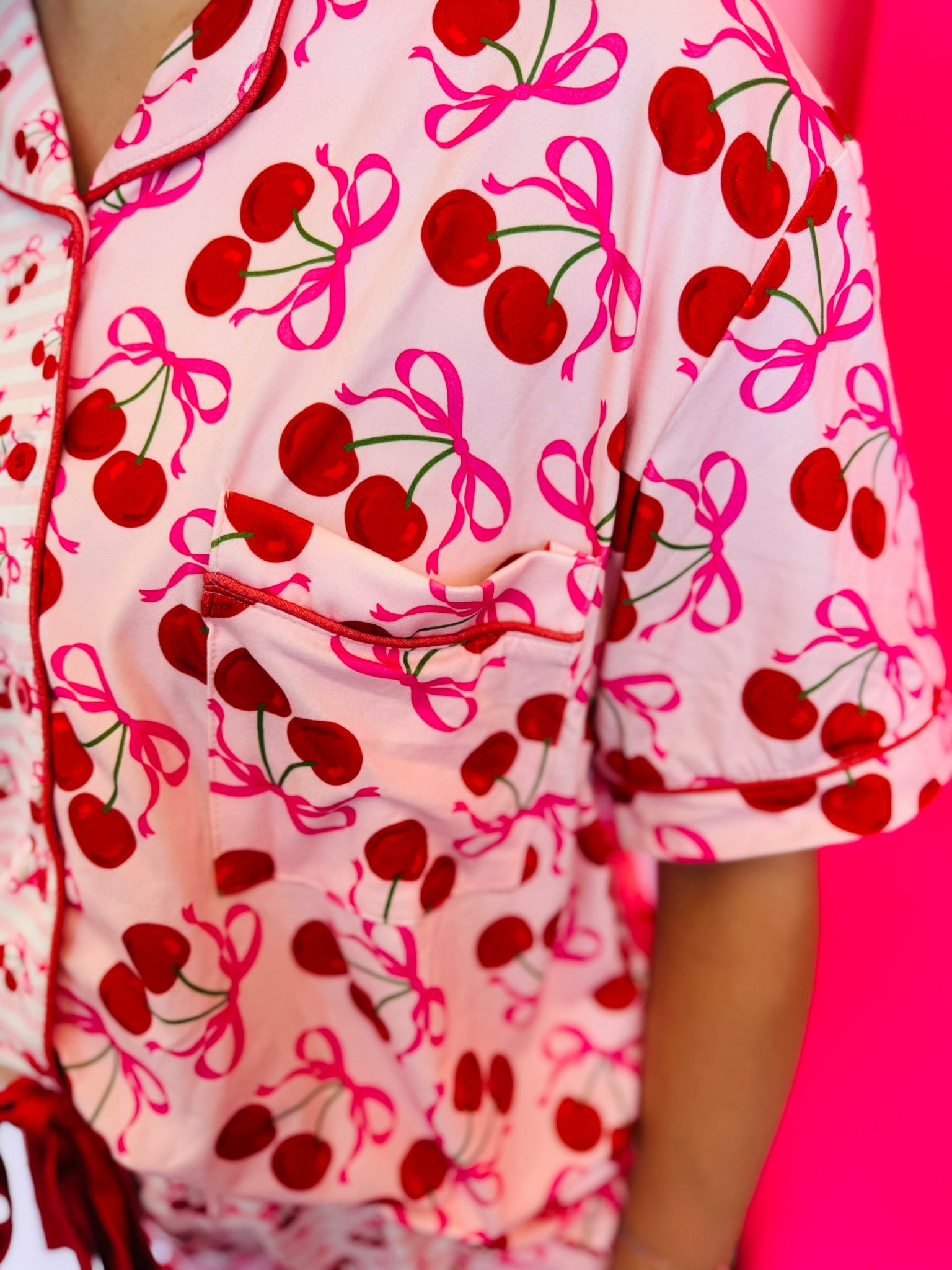 Close-up image highlighting the cherry print design on the pajama top, showing the vibrant red cherries and playful pattern.