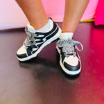 Black and white sneakers with a bold wave design, thick platform sole, and zigzag laces — modern, sporty, and edgy.