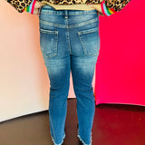 Rear view of cropped denim with high-rise waist, straight-leg fit, and raw hem detail
