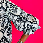 3/4 length balloon sleeve with decorative trim at cuff in black damask print.