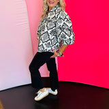 Black button-down blouse with baroque-inspired damask print, structured collar, and 3/4 length balloon sleeves with decorative trim.