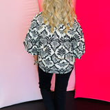 Rear view displaying allover black damask print and tailored back seam detailing
