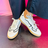 White low-top sneakers with vegan leather upper, delicate lace trim, lace-up closure, and round toe.
